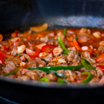 Delicious Mexican stir fry featuring bell peppers and tender meat in a sizzling pan.